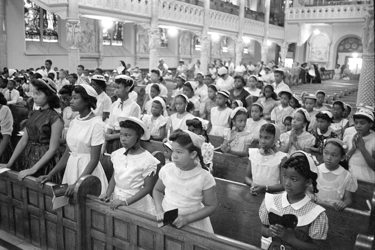 Children of St. Elizabeth's parish, most of them equipped with missals to follow the liturgy, stand for the reading of the Gospel in 1955. The image is part of a series by photographer Jerry Dantzic — a rare, compassionate view of the African American community’s rich spiritual life, writes Dantzic's son, Grayson.